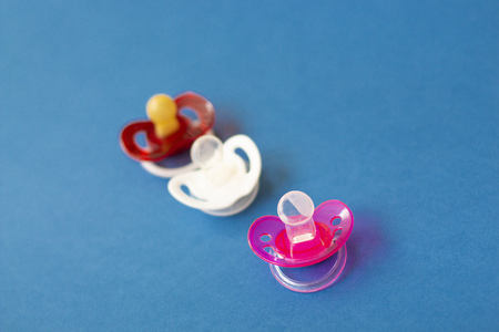 baby pacifiers are on a blue backgroundの写真素材
