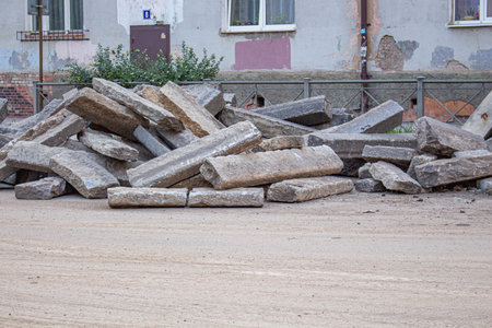 repair of roads.the curb from the dismantled road lies on the asphalt