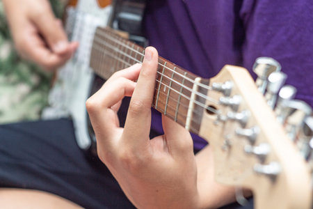 man hands closeup play the guitar