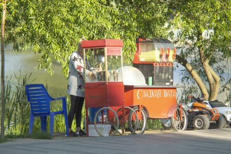 Russia Kaliningrad 2019 girl sells cotton candy and coffee on the streetのeditorial素材