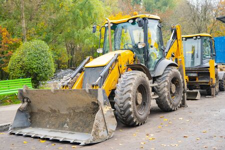 yellow excavator stands on the construction siteの写真素材
