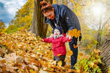 autumn.a mother and her child walking in autumn Park and smilingの写真素材