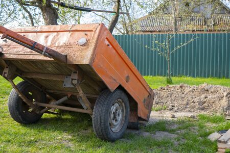 an orange trailer stands in a clearing1の写真素材