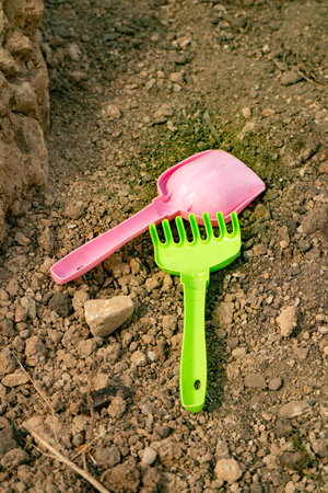 children's shovel and rake lie on the ground1