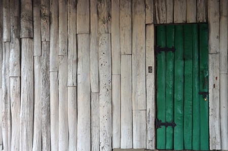 wooden green door and white wallの写真素材