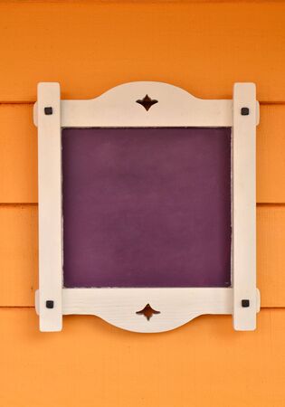 purple board on orange wood wallの写真素材