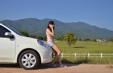 pretty women use her phone in the countryの写真素材