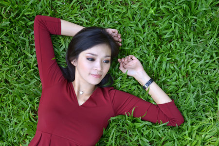 pretty woman in red dress at the gardenの写真素材