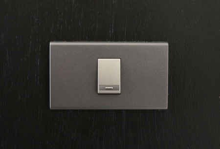 Black toggle switch on black surfaceの写真素材