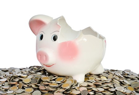 Pink piggy bank broken with money isolated on white backgroundの写真素材