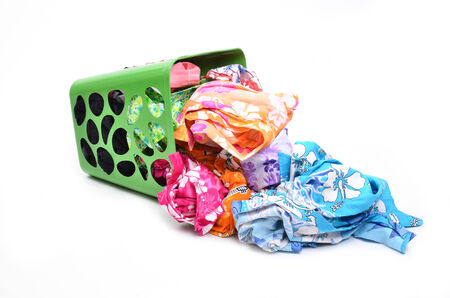 unwashed cloth in the basket on white backgroundの写真素材