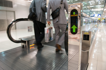 airport escalator with unrecognizable people walking onのeditorial素材