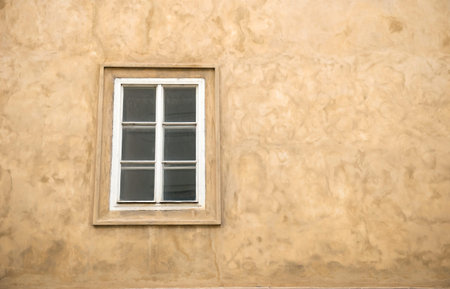 a window on yellow wall