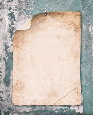 old paper on cyan cracked  concrete wallの写真素材