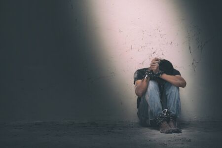 hopeless man hands tied together with rope, human traffickingの写真素材