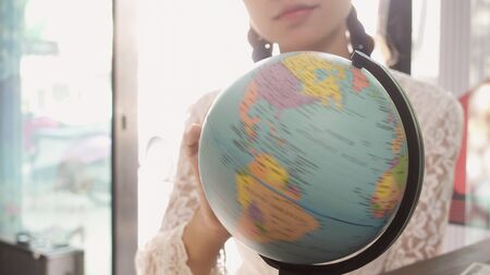 Women explore the globe to plan their travelの写真素材