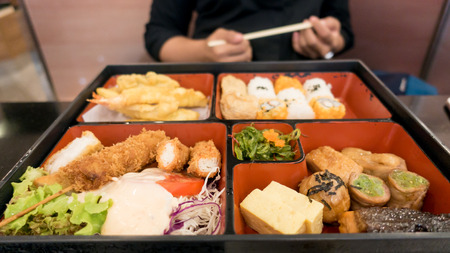 women eating  bento box set in japanese restaurantの写真素材