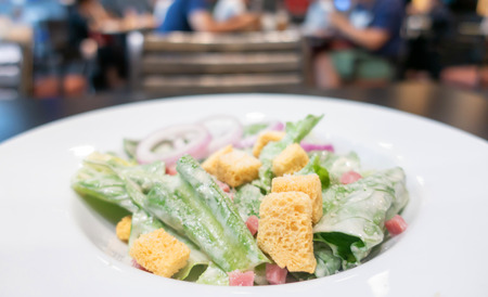 Fresh healthy Caesar salad on white dishの写真素材