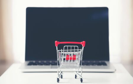 shopping cart with laptop on the desk, online shopping conceptの写真素材