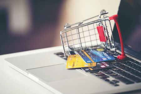 online shopping concept, Shopping cart and credit card with laptop on the deskの写真素材