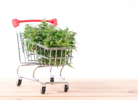 fresh marijuana flower in shopping cart on tableの写真素材