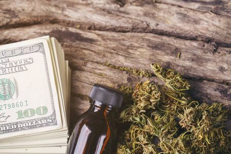 dried medical marijuana with CBD  THC extract and dollar banknoteの写真素材