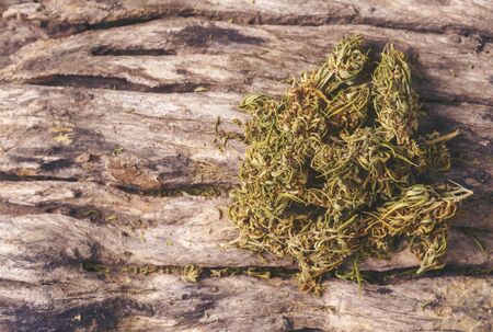 dried cannabis medical marijuana on wooden backgroundの写真素材