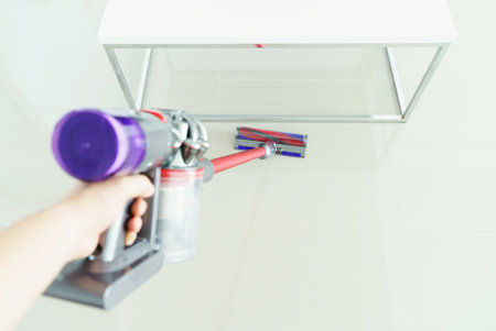 woman clean floor with a vacuum cleaner at homeの写真素材