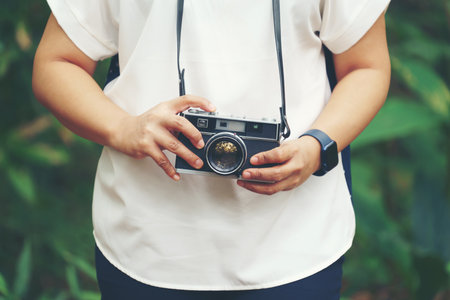 woman with vintage camera in parkの写真素材