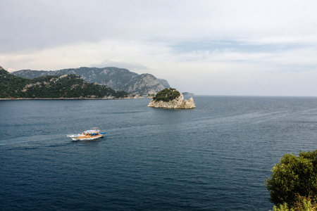boat in the sea and mountains in background