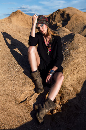 Girl sitting in desert