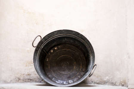 ancient bowl on stone wallの写真素材