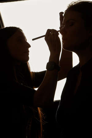 Silhouette photo of makeup artist workingの写真素材