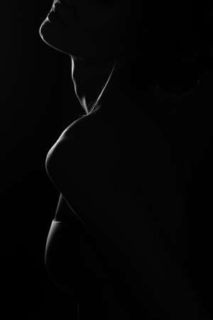 Black and white profile portrait of female in back lit art photographyの写真素材