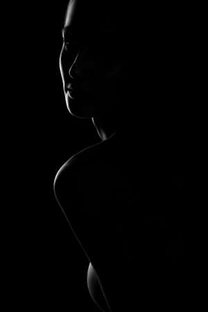 Black and white profile portrait of female in back lit art photographyの写真素材