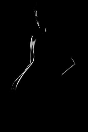 black and white female body in back light art photographyの写真素材