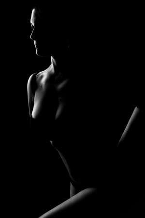 black and white female body in back light art photographyの写真素材