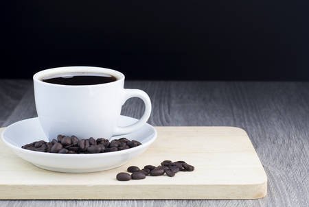 black coffee with coffee bean on wooden tableの写真素材
