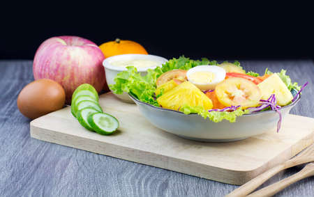 Fresh organic salad with dipping sauce on wooden for good healthy and dietの写真素材