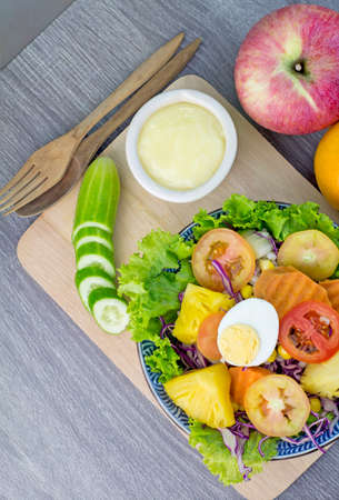 Fresh organic salad with dipping sauce on wooden for good healthy and dietの写真素材