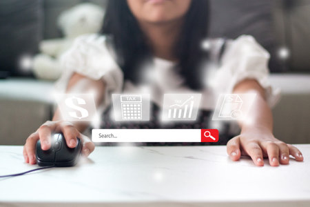 Close up of woman using computer mouse at home. Online shopping concept.の写真素材