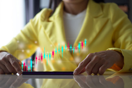 business woman using tablet with stock market chart on screen, financial conceptの写真素材