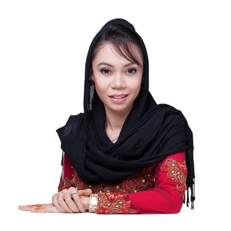 Beautiful muslim lady wear red with hijab, smile and look at cameraの写真素材