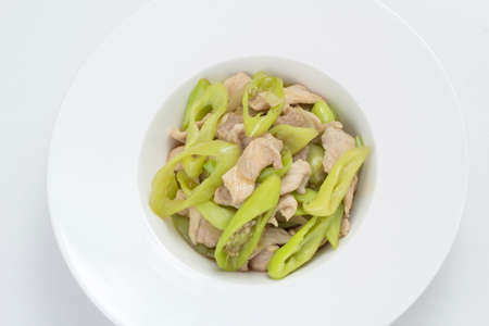 pork fried with sweet pepper. Thai food on white dishの写真素材