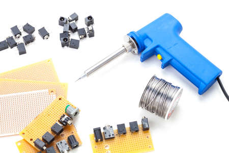 Soldering Gun Shape Placed on a white background isolated with electronic devices and consumer electronics such as audio jack and power jack female put together .の写真素材