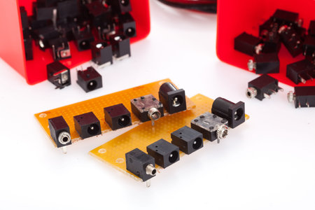 Printed circuit board kits mounting with too many kind of connector. Place on white table.