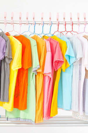 Multi-colored T-shirts hanging on a clothes line . After washing doneの写真素材