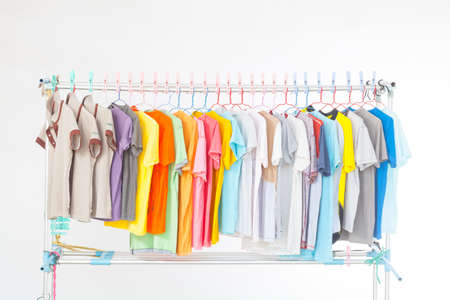 Multi-colored T-shirts hanging on a clothes line . After washing doneの写真素材