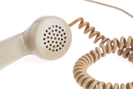 handset of antique telephone placed on isolate white background. Closed up on microphone