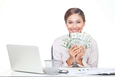 Asian business woman hold some of bank notes in hand with smiling face. isolated whiteの写真素材